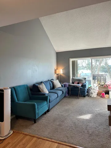 a living room with furniture and large windows