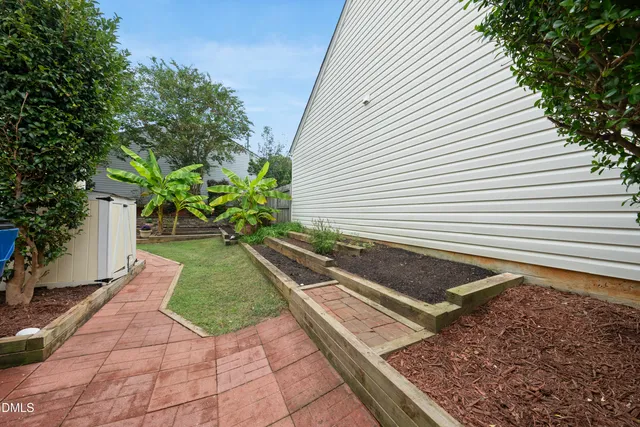 a view of patio with table and chairs and potted plants
