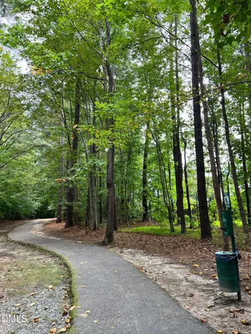 a view of backyard with wooden fence