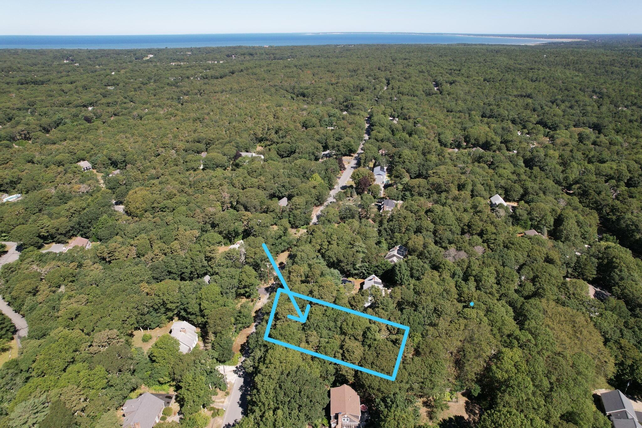 0 Commons Way Brewster, MA 02631 - Photo 2 of 13 a view of a city with lush green forest
