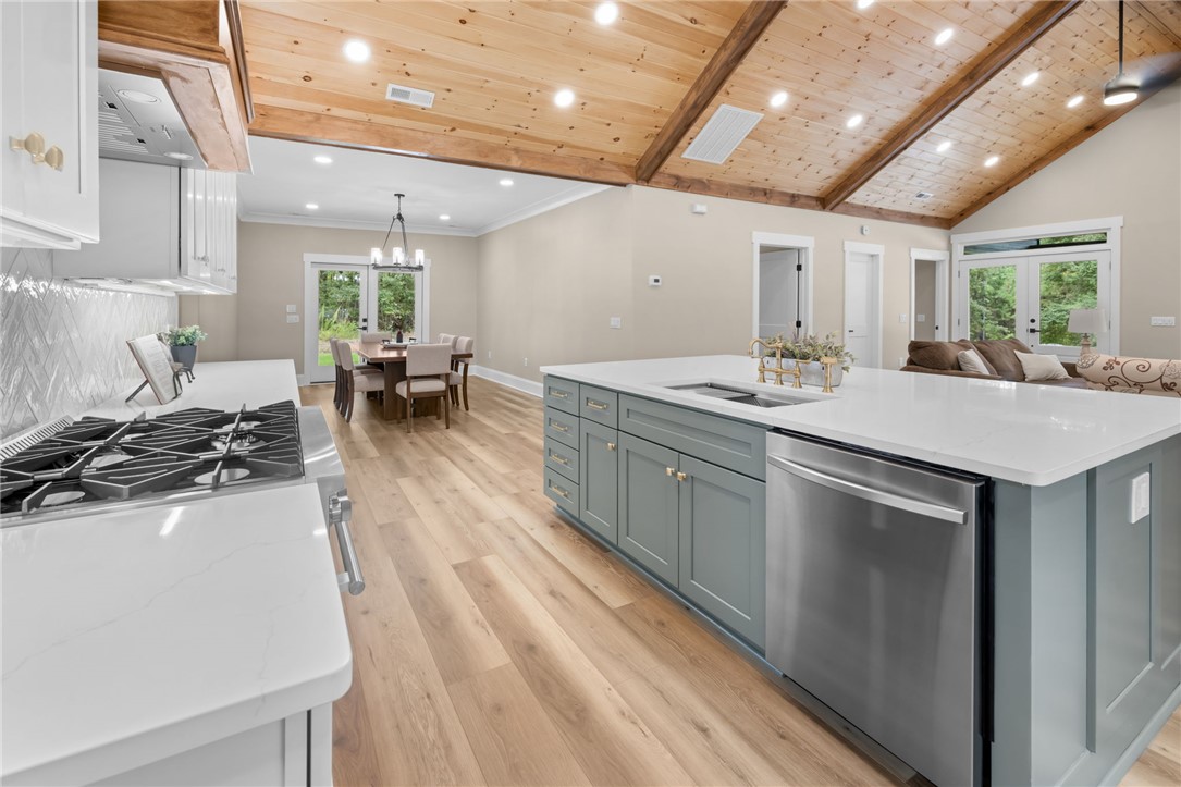147 McAlister Road West Union, SC 29696 - Photo 49 of 50 An open floor plan connects the kitchen to the dining and living spaces under vaulted wood ceilings.