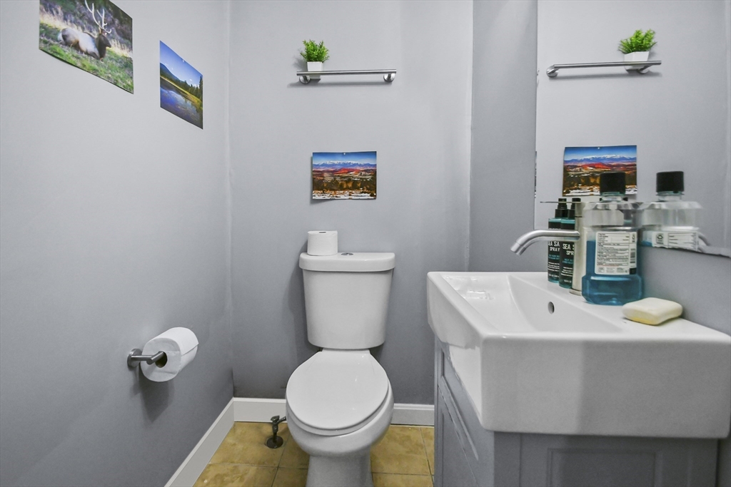 36 Union Street, Unit 36 Woburn, MA 01801 - Photo 6 of 13 a bathroom with a sink mirror and toilet