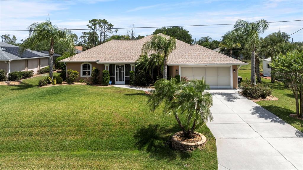 1240 Alpinia Road North Port, FL 34288 - Photo 1 of 1 a backyard of a house with yard and outdoor seating