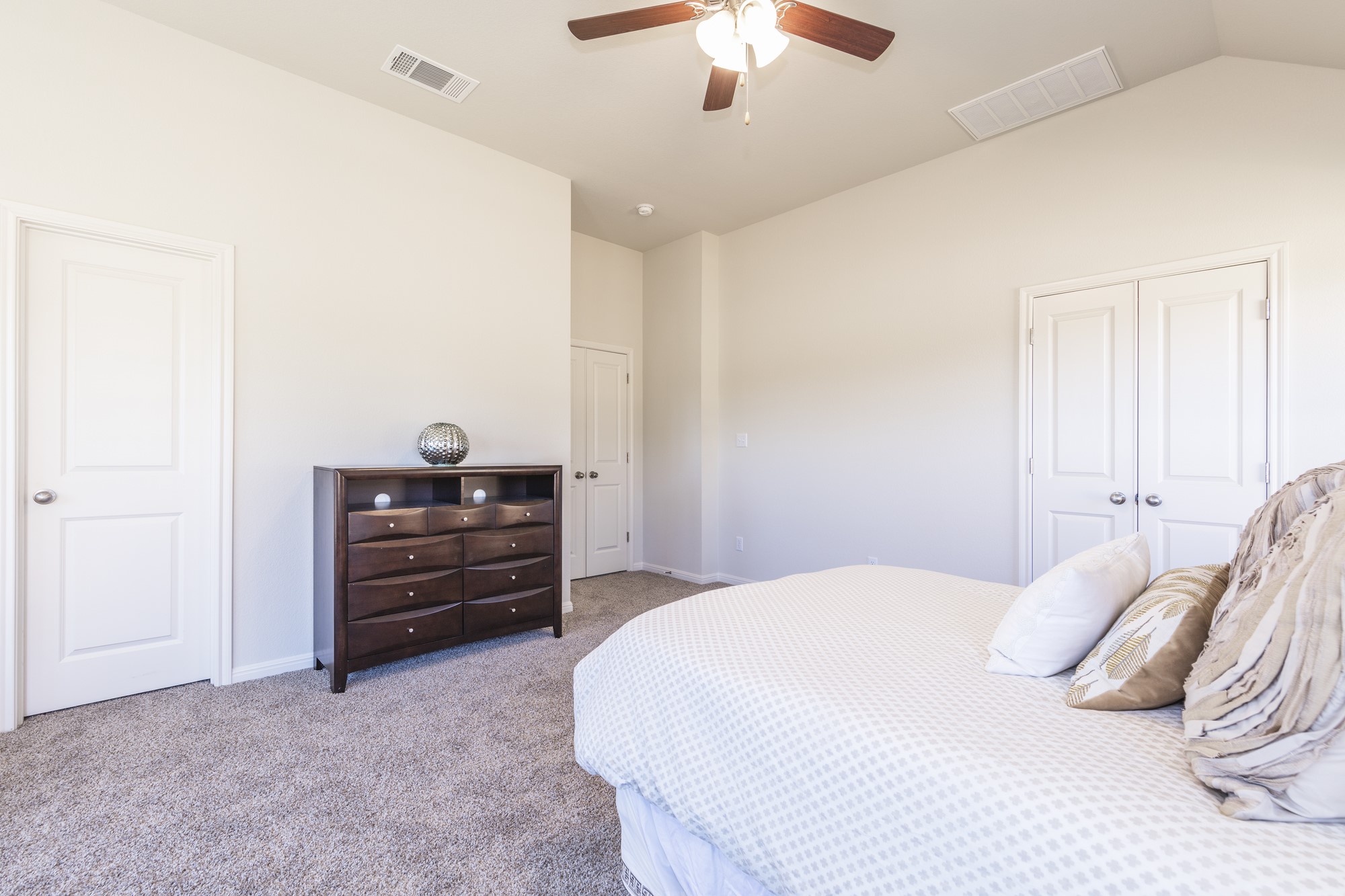 2725 Hopi Path Leander, TX 78641 - Photo 27 of 30 A restful primary bedroom featuring high vaulted ceilings and cozy carpeted flooring for ultimate comfort.