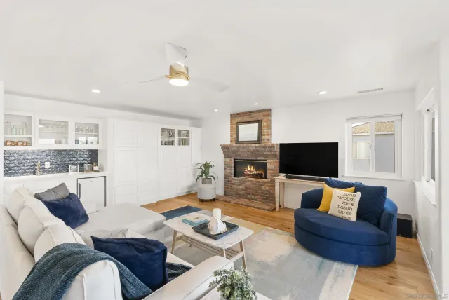 a living room with furniture a fireplace and a flat screen tv