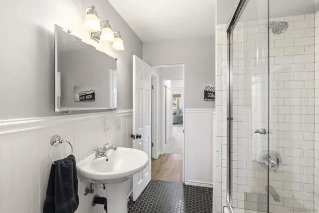 a bathroom with a sink toilet vanity and shower