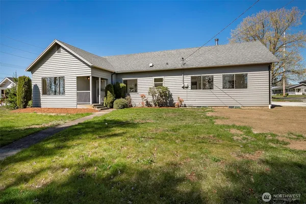 a front view of house with yard and green space