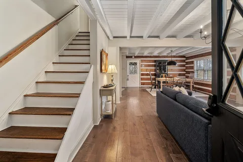 a view of entryway and hall with wooden floor