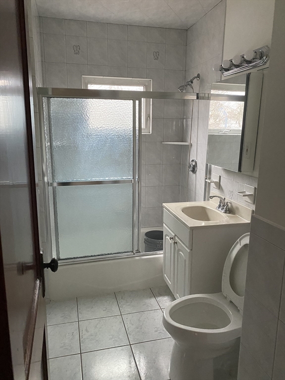 19-21 Virgil Road, Unit 1 Boston, MA 02132 - Photo 12 of 13 a bathroom with a granite countertop shower toilet and sink