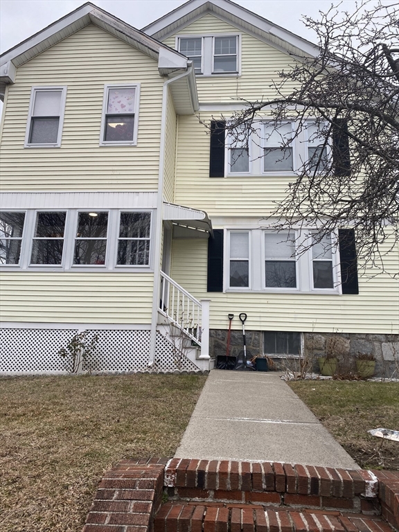 19-21 Virgil Road, Unit 1 Boston, MA 02132 - Photo 13 of 13 a front view of a house with a yard