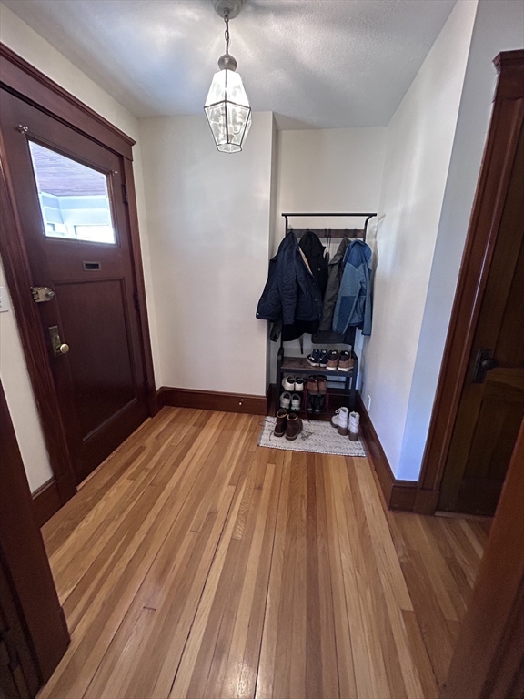 19-21 Virgil Road, Unit 1 Boston, MA 02132 - Photo 3 of 13 a view of a room with wooden floor and staircase