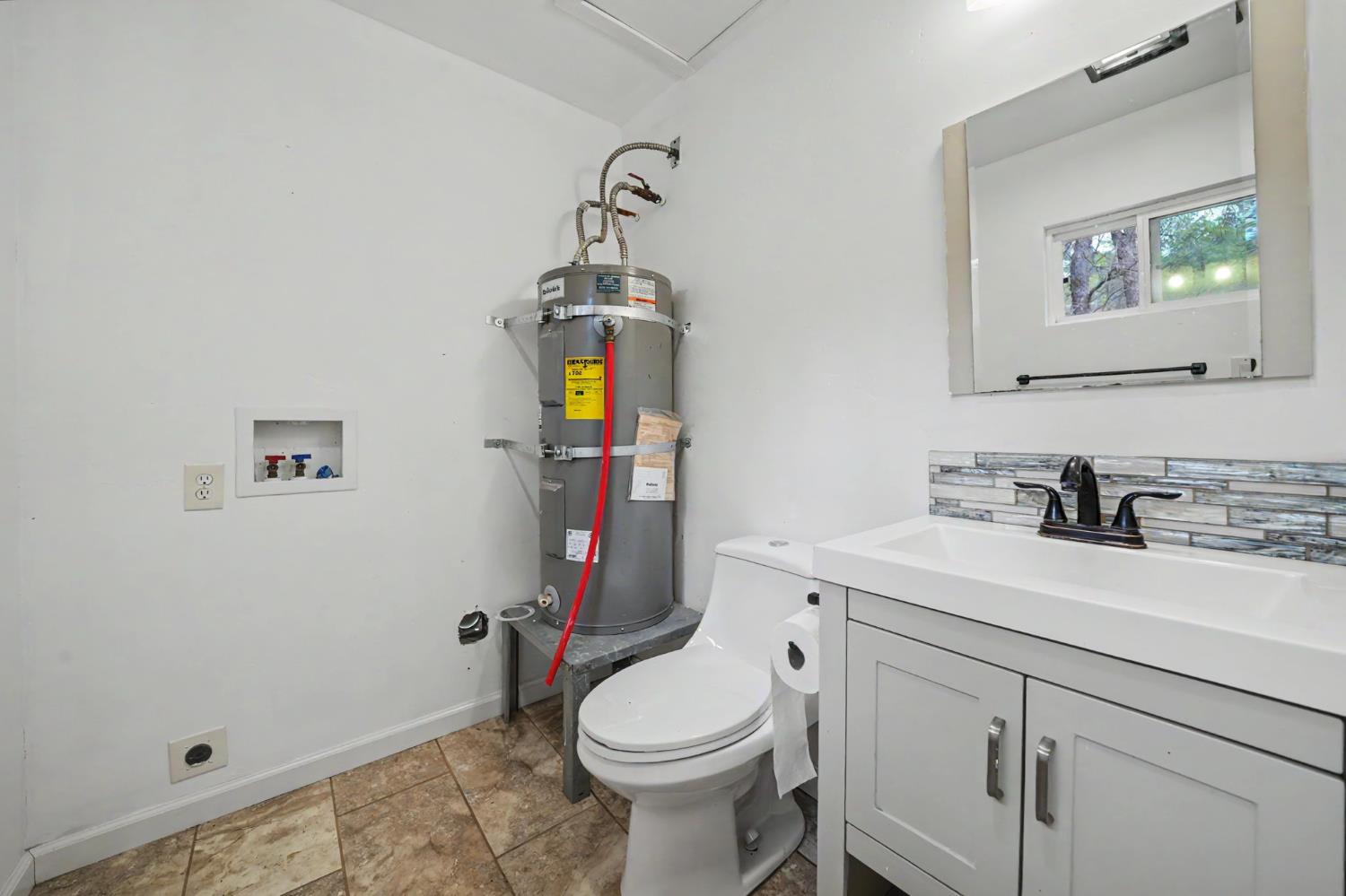67 Winton Road West Point, CA 95255 - Photo 16 of 28 a bathroom with a granite countertop toilet sink and mirror
