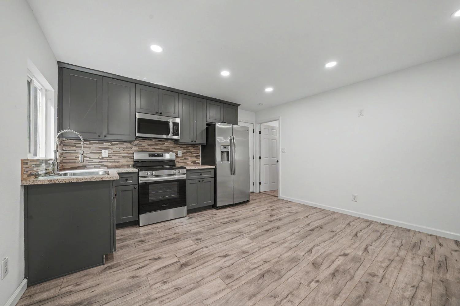 67 Winton Road West Point, CA 95255 - Photo 8 of 28 a kitchen with a refrigerator a sink and a stove top oven