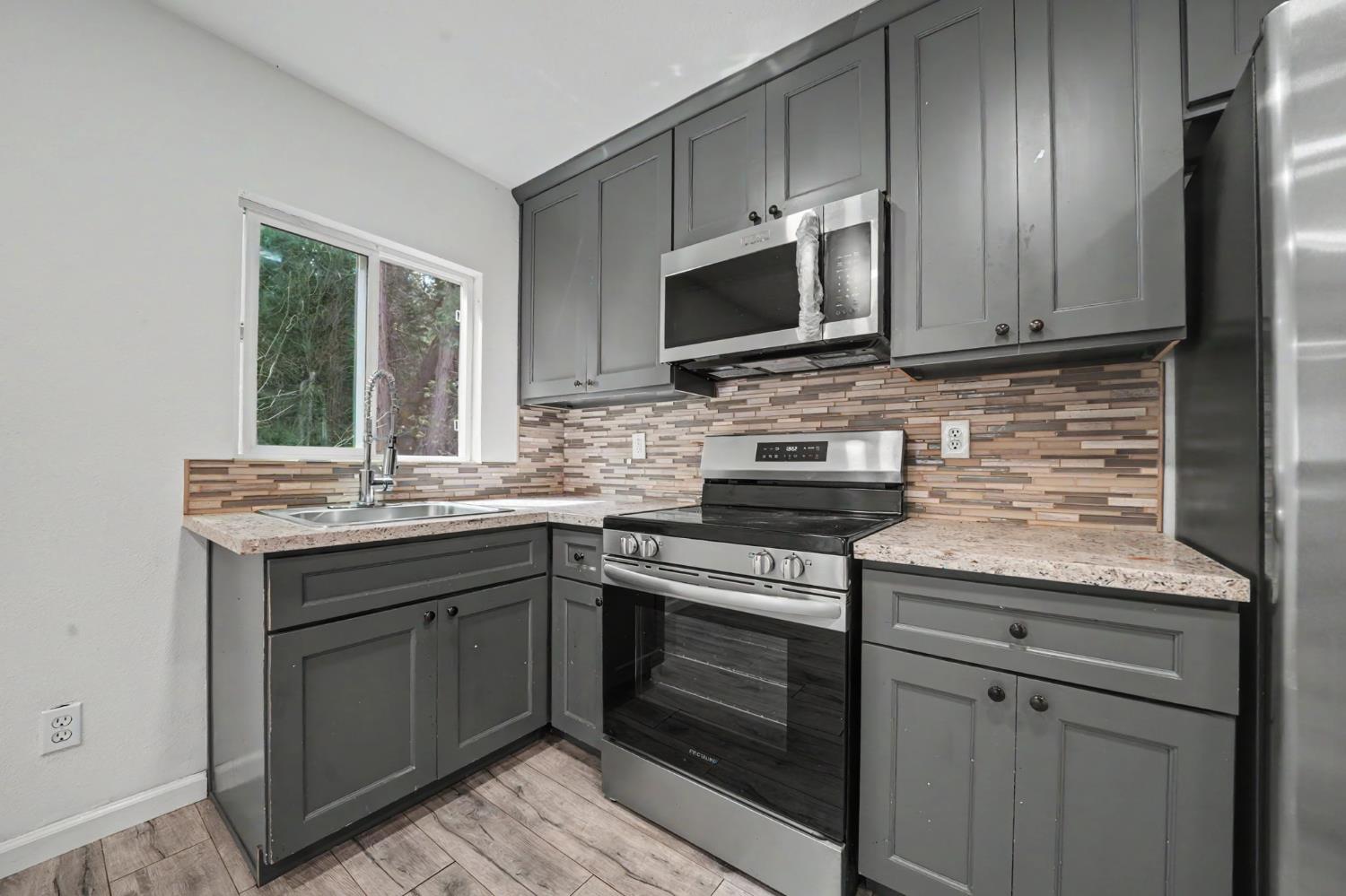 67 Winton Road West Point, CA 95255 - Photo 9 of 28 a kitchen with stainless steel appliances granite countertop a stove microwave and oven