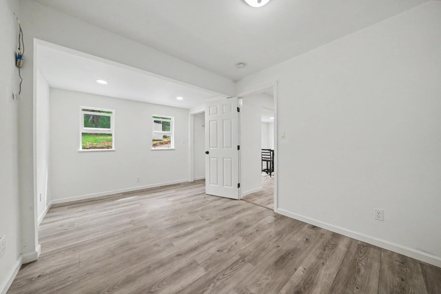 67 Winton Road West Point, CA 95255 - Photo 10 of 28 an empty room with wooden floor and windows