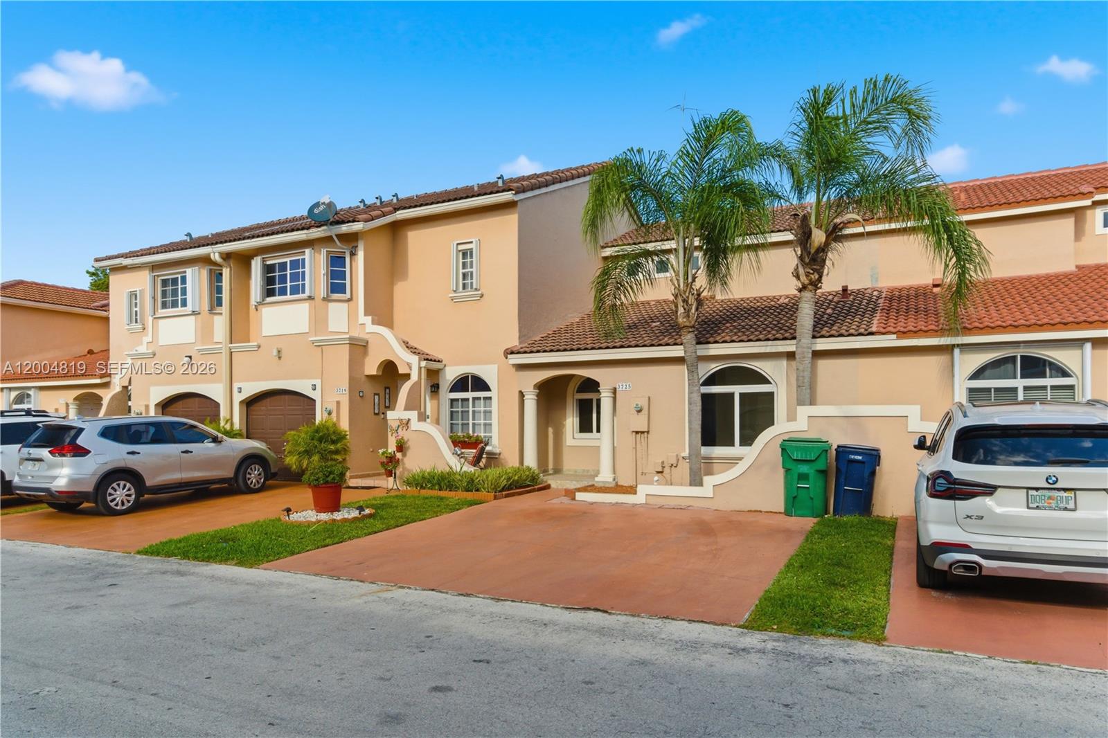 3725 Southwest 153rd Court Miami, FL 33185 - Photo 2 of 28 a front view of a house with garden and parking