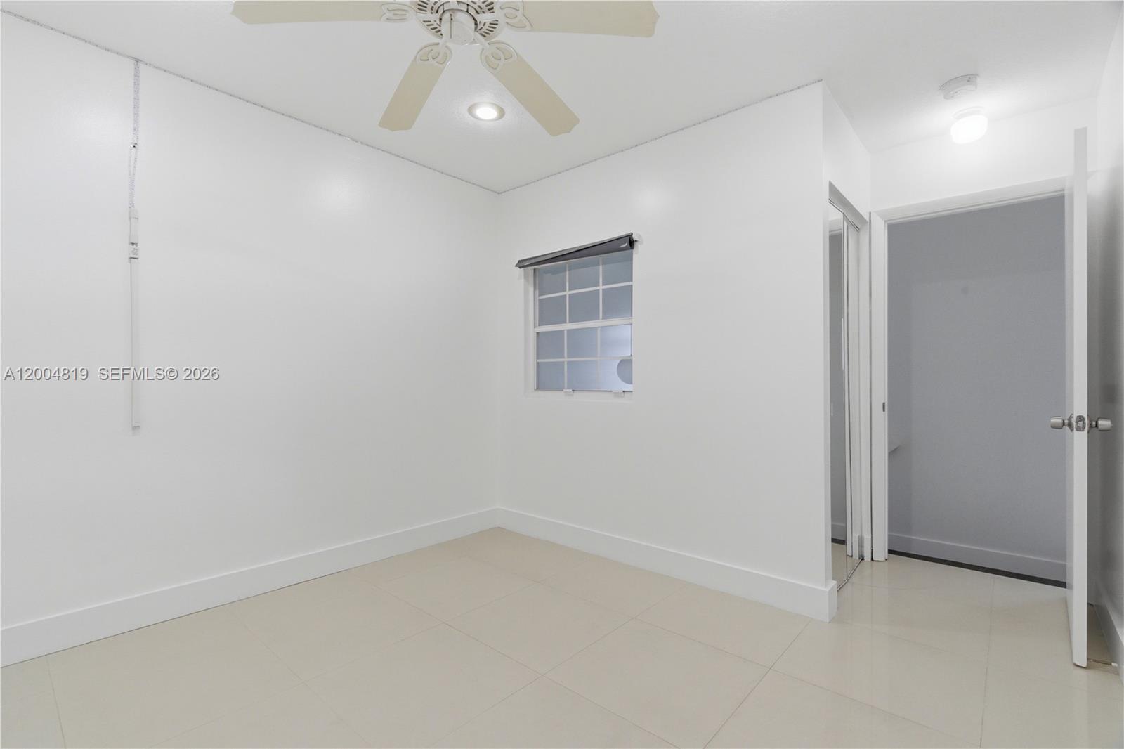 3725 Southwest 153rd Court Miami, FL 33185 - Photo 24 of 28 an empty room with a ceiling fan and window