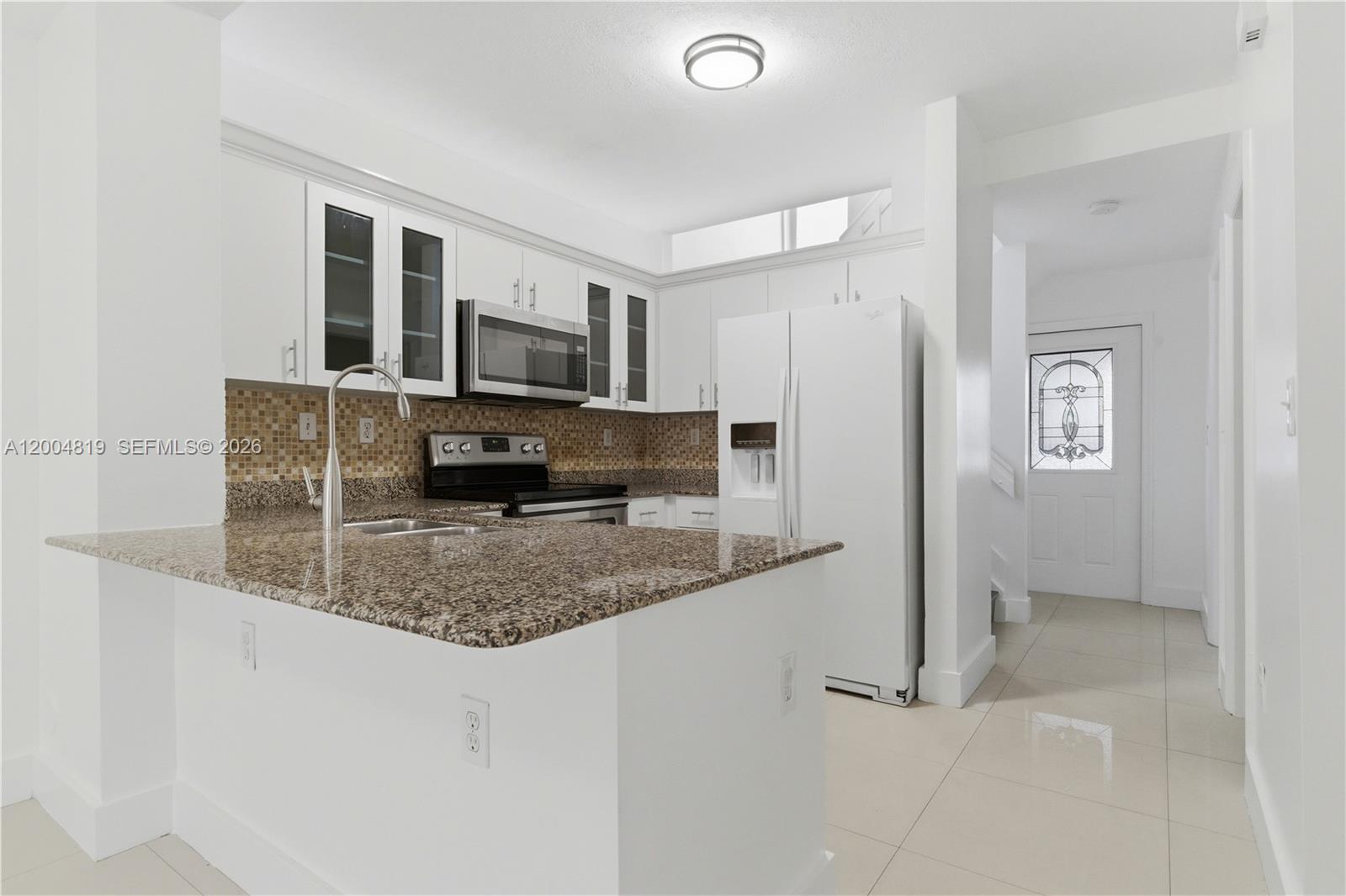 3725 Southwest 153rd Court Miami, FL 33185 - Photo 9 of 28 a kitchen with refrigerator and window