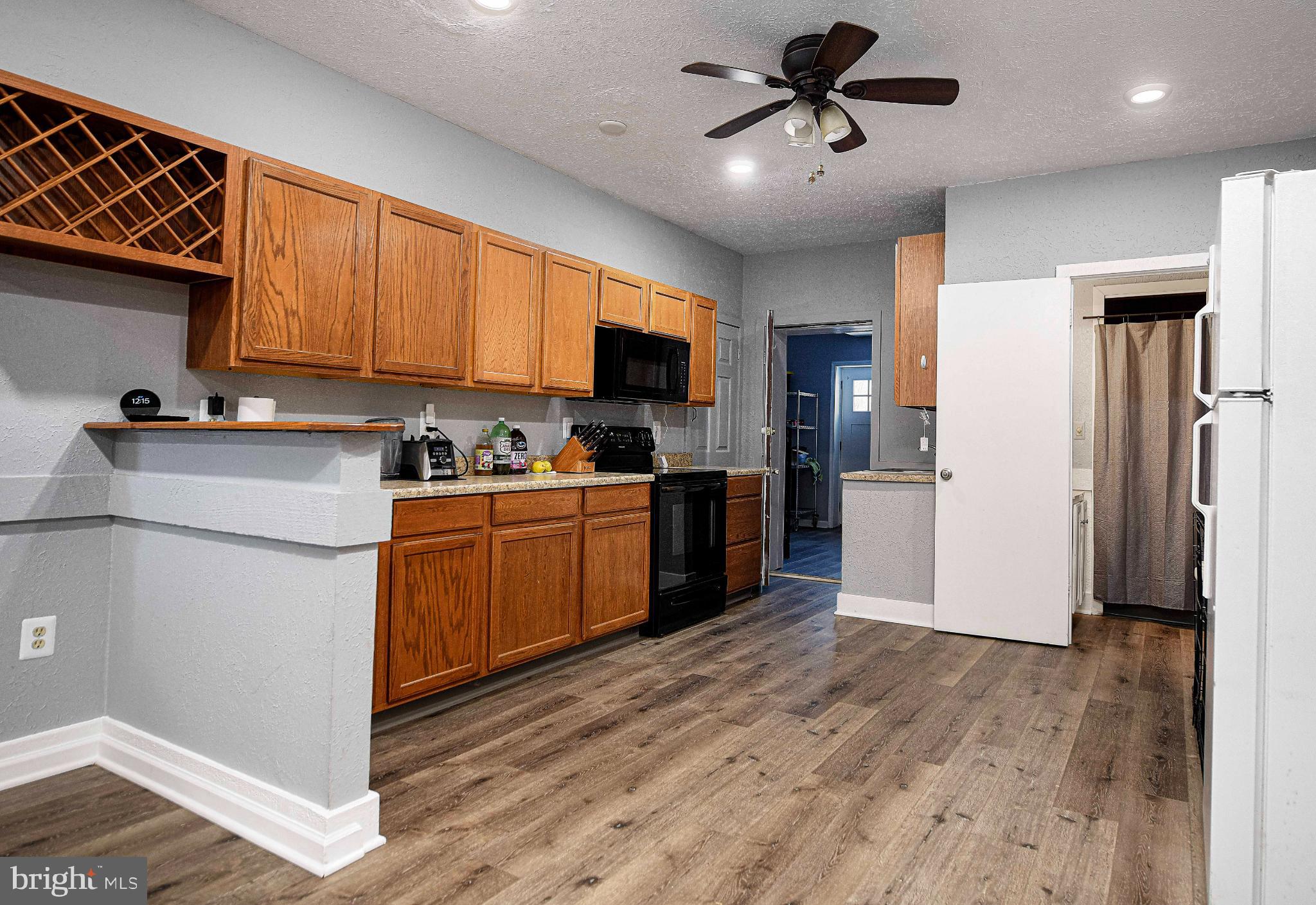 1221 Prospect Mill Road Bel Air, MD 21015 - Photo 42 of 81 a kitchen with granite countertop a refrigerator a stove top oven a sink and cabinets