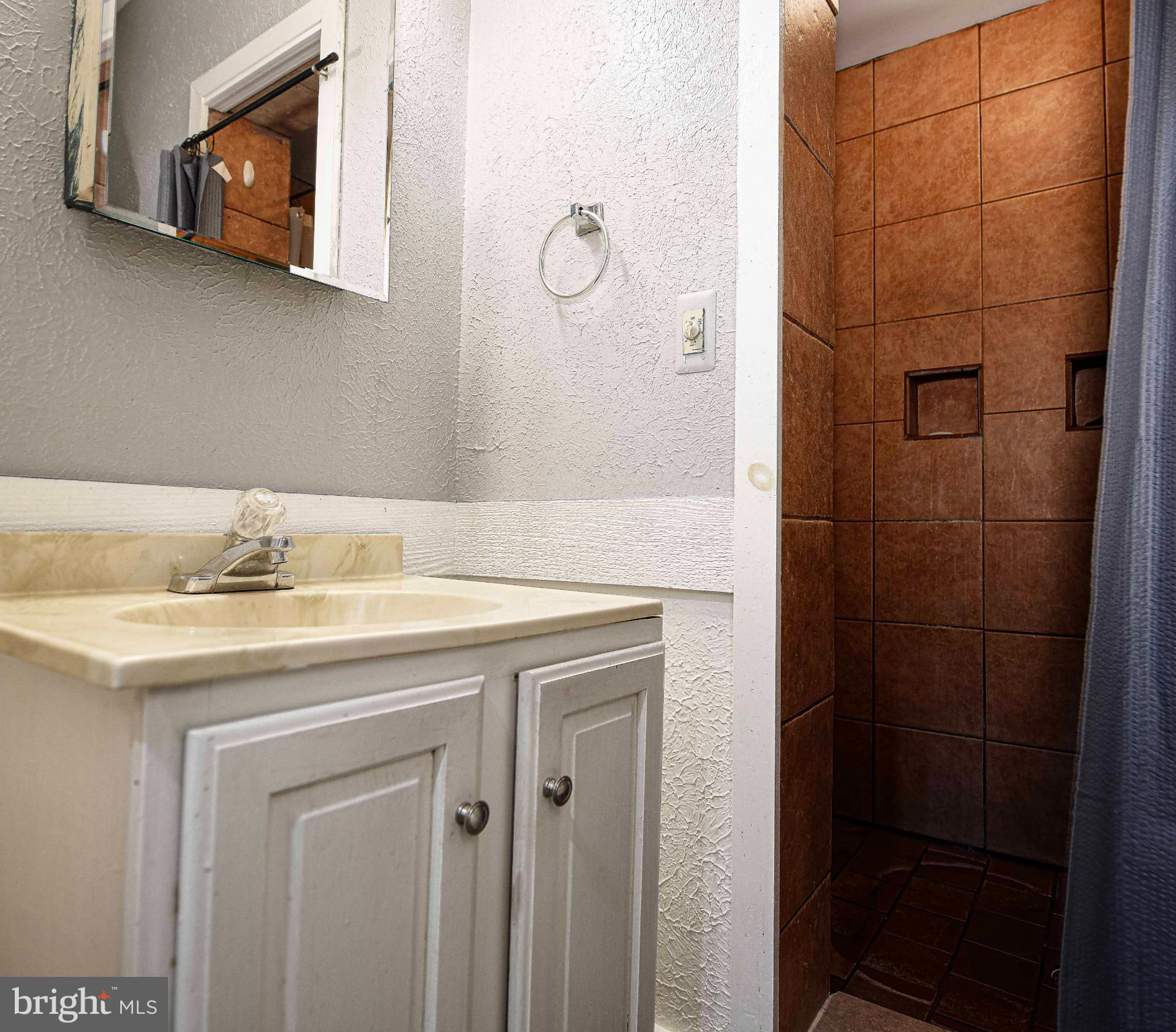1221 Prospect Mill Road Bel Air, MD 21015 - Photo 48 of 81 a bathroom with a granite countertop sink a mirror and vanity