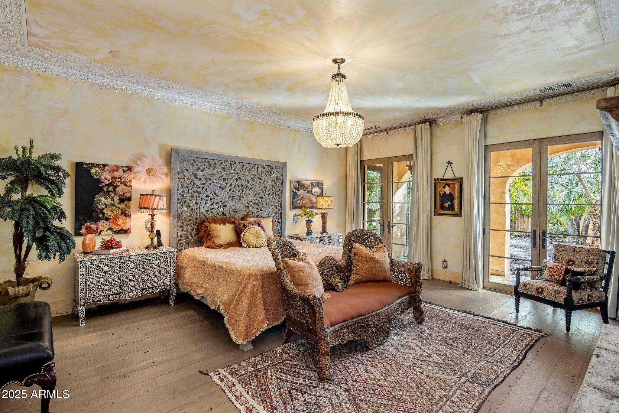 66 Biltmore Estates Drive Phoenix, AZ 85016 - Photo 12 of 54 a bedroom with a bed and a chandelier