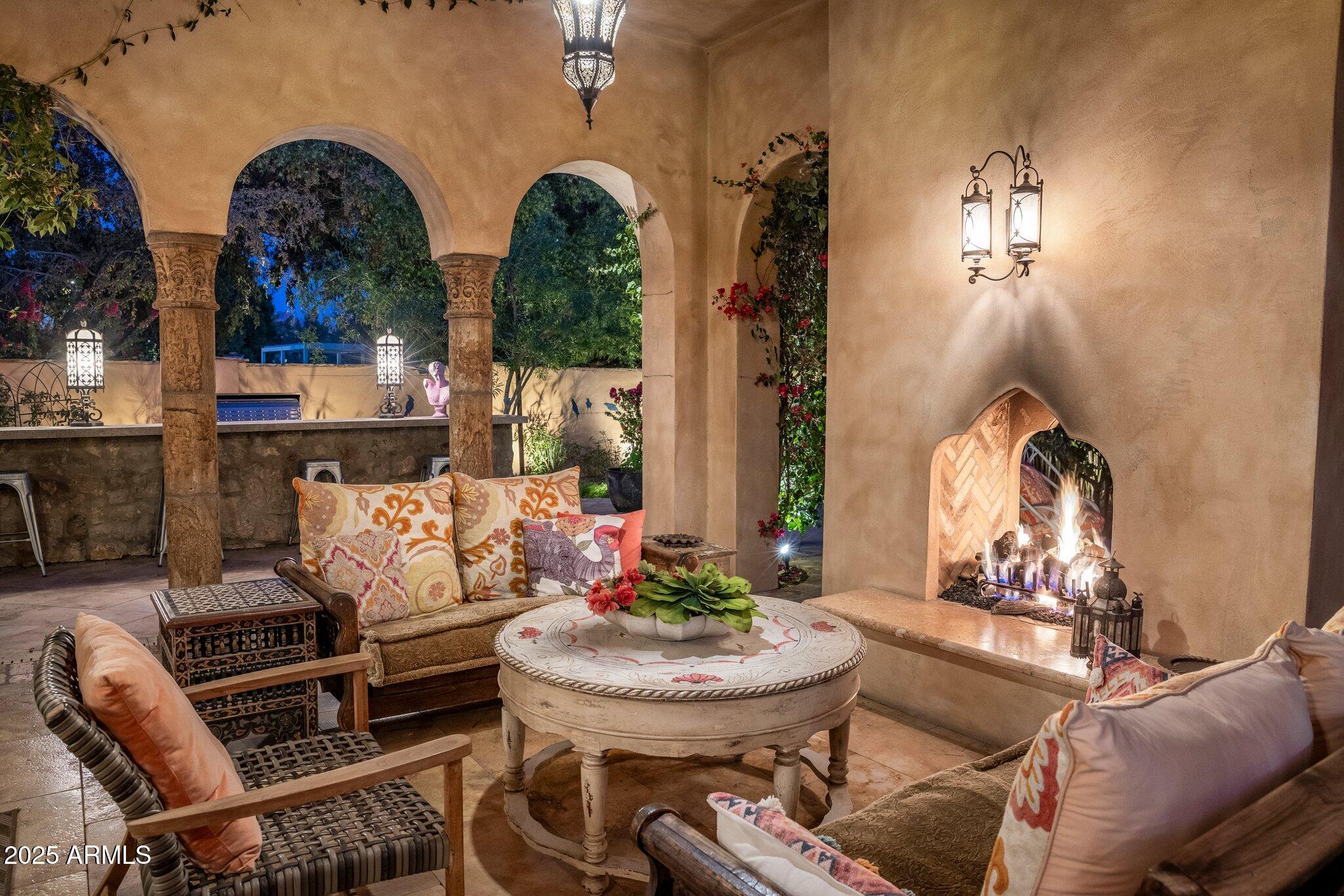 66 Biltmore Estates Drive Phoenix, AZ 85016 - Photo 8 of 54 a living room with couches chandelier and a fireplace