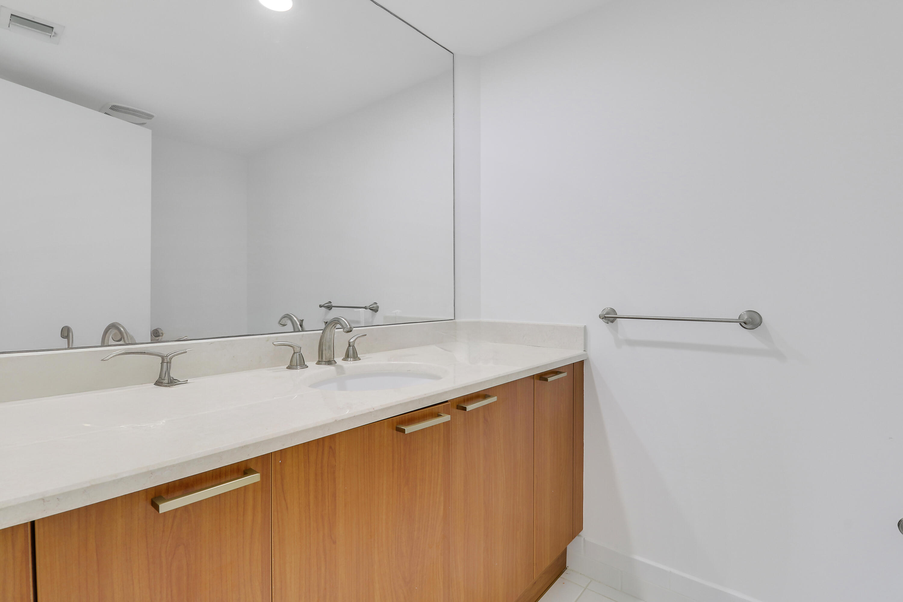 2640 Lake Shore Drive, Unit 307 Riviera Beach, FL 33404 - Photo 37 of 44 a bathroom with a sink and a mirror