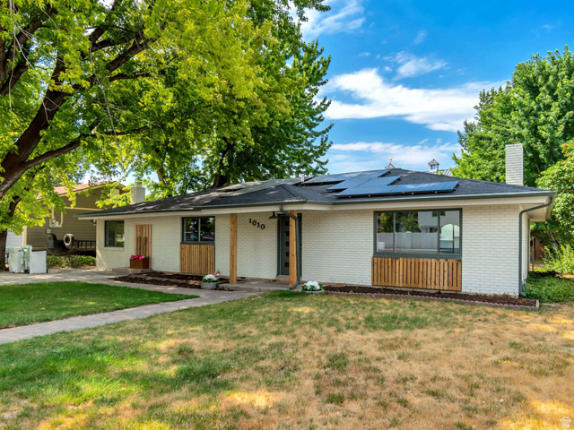 1010 West Maple Street Mapleton, UT 84664 - Photo 2 of 24 White brick residence with a dark roof and solar panels