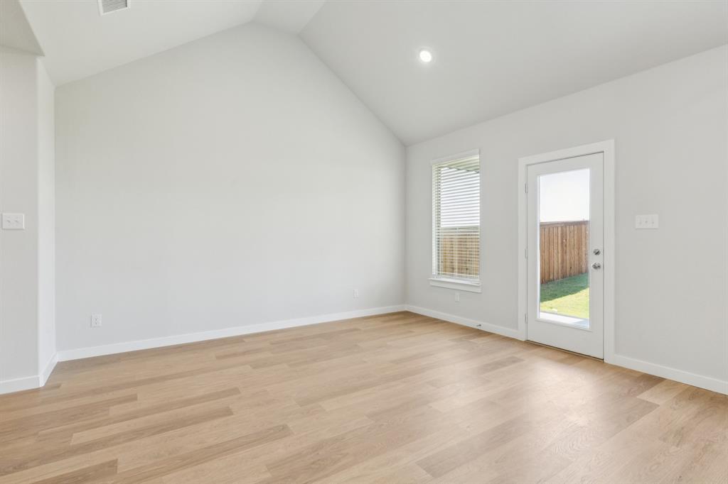 1469 Barbacoa Drive Haslet, TX 76052 - Photo 12 of 35 an empty room with wooden floor and windows