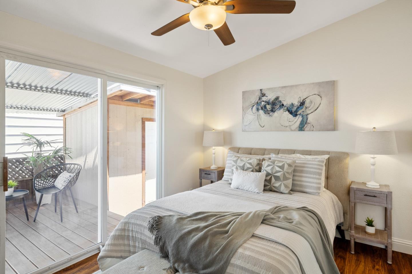 14685 Oka Road, Unit 62 Los Gatos, CA 95032 - Photo 11 of 27 a bedroom with a large bed and a chandelier