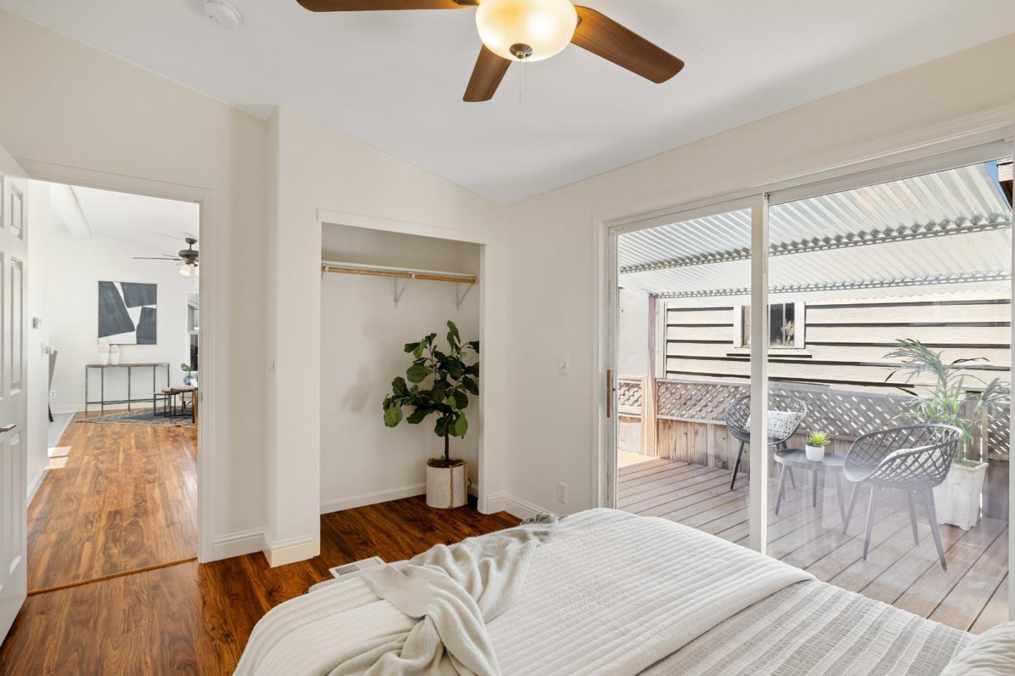 14685 Oka Road, Unit 62 Los Gatos, CA 95032 - Photo 12 of 27 a bedroom with a balcony a bed and dresser with wooden floor