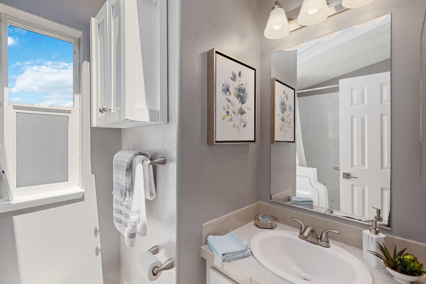 14685 Oka Road, Unit 62 Los Gatos, CA 95032 - Photo 14 of 27 a bathroom with a sink and a mirror