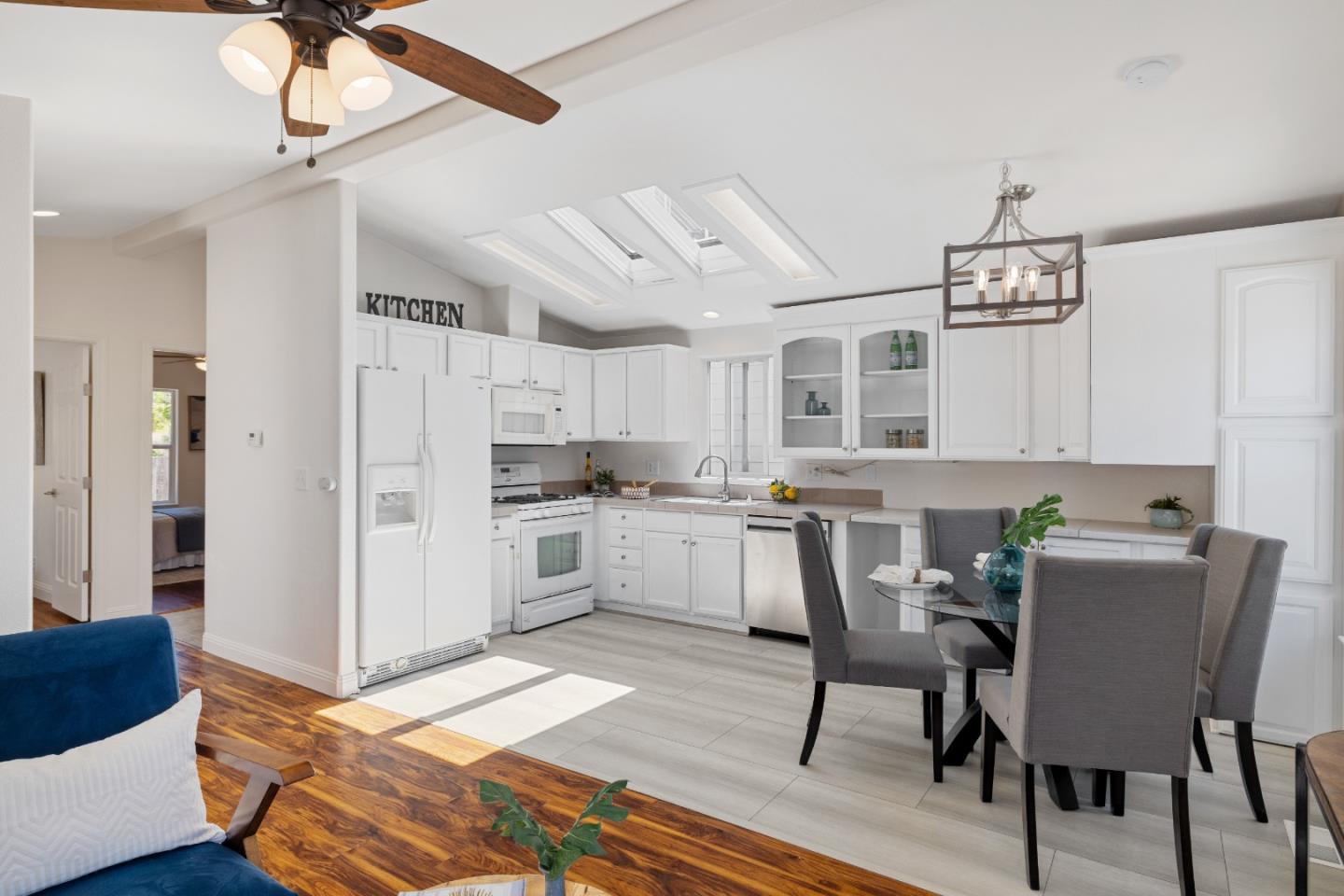 14685 Oka Road, Unit 62 Los Gatos, CA 95032 - Photo 5 of 27 a kitchen with stainless steel appliances granite countertop a dining table chairs sink and cabinets
