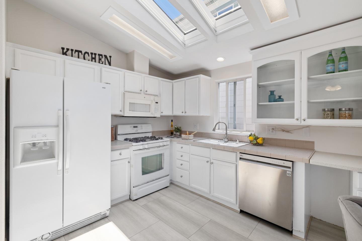 14685 Oka Road, Unit 62 Los Gatos, CA 95032 - Photo 6 of 27 a kitchen with white cabinets appliances and a sink