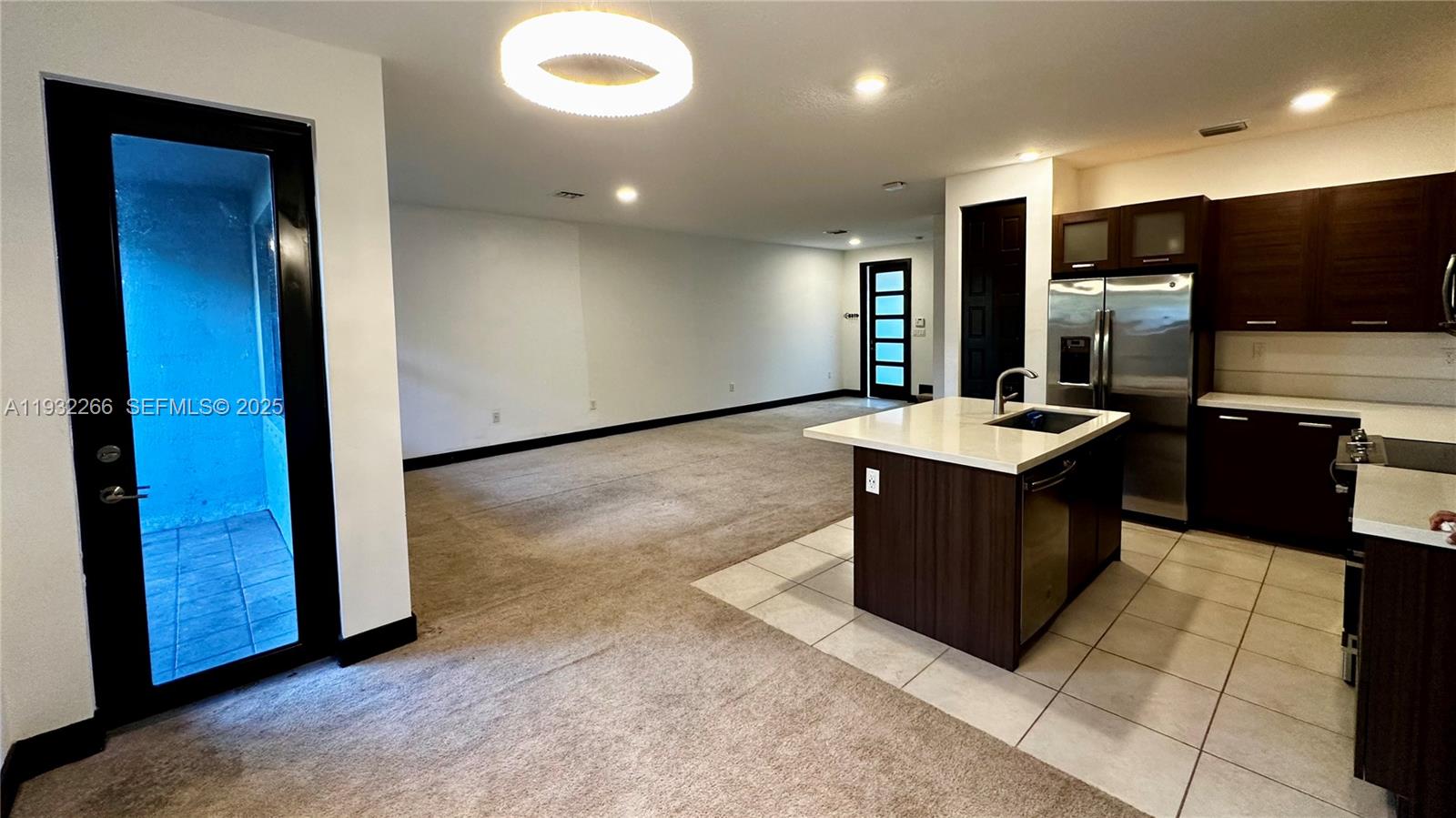 9155 Northwest 161st Street Miami Lakes, FL 33018 - Photo 18 of 51 a kitchen with stainless steel appliances kitchen island granite countertop a refrigerator and a sink
