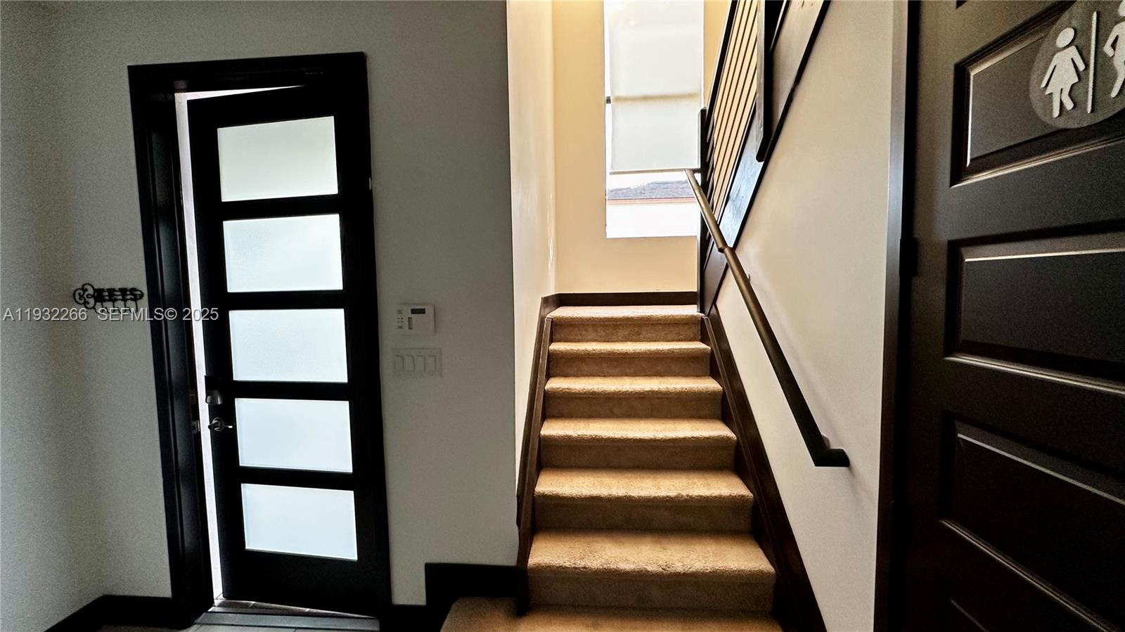 9155 Northwest 161st Street Miami Lakes, FL 33018 - Photo 19 of 51 a view of staircase with wooden floor and a window