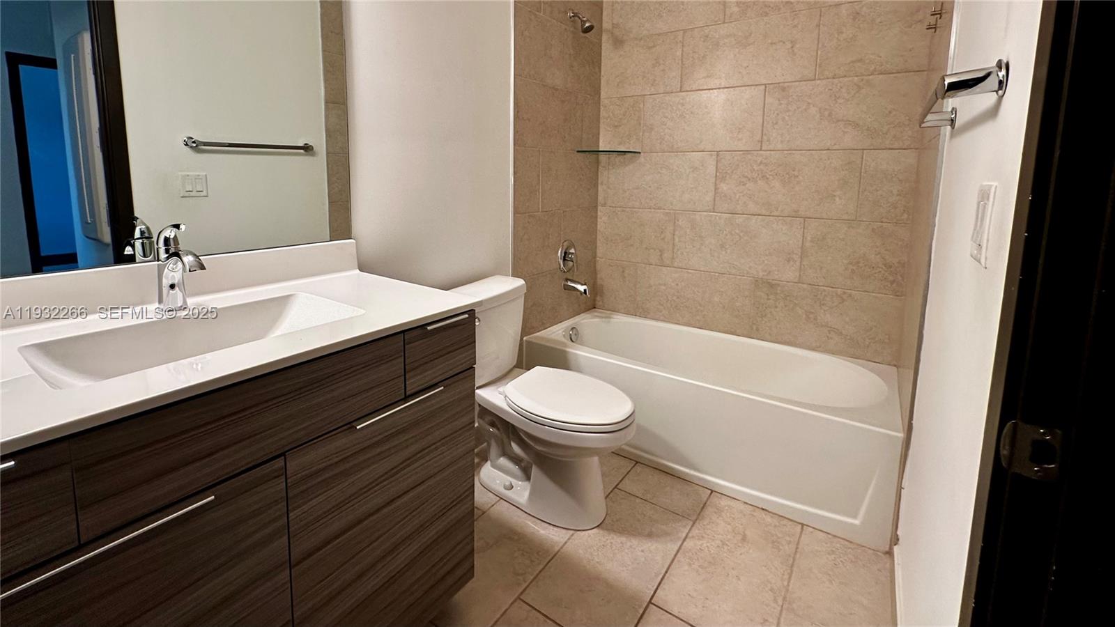 9155 Northwest 161st Street Miami Lakes, FL 33018 - Photo 39 of 51 a bathroom with a sink a toilet and shower