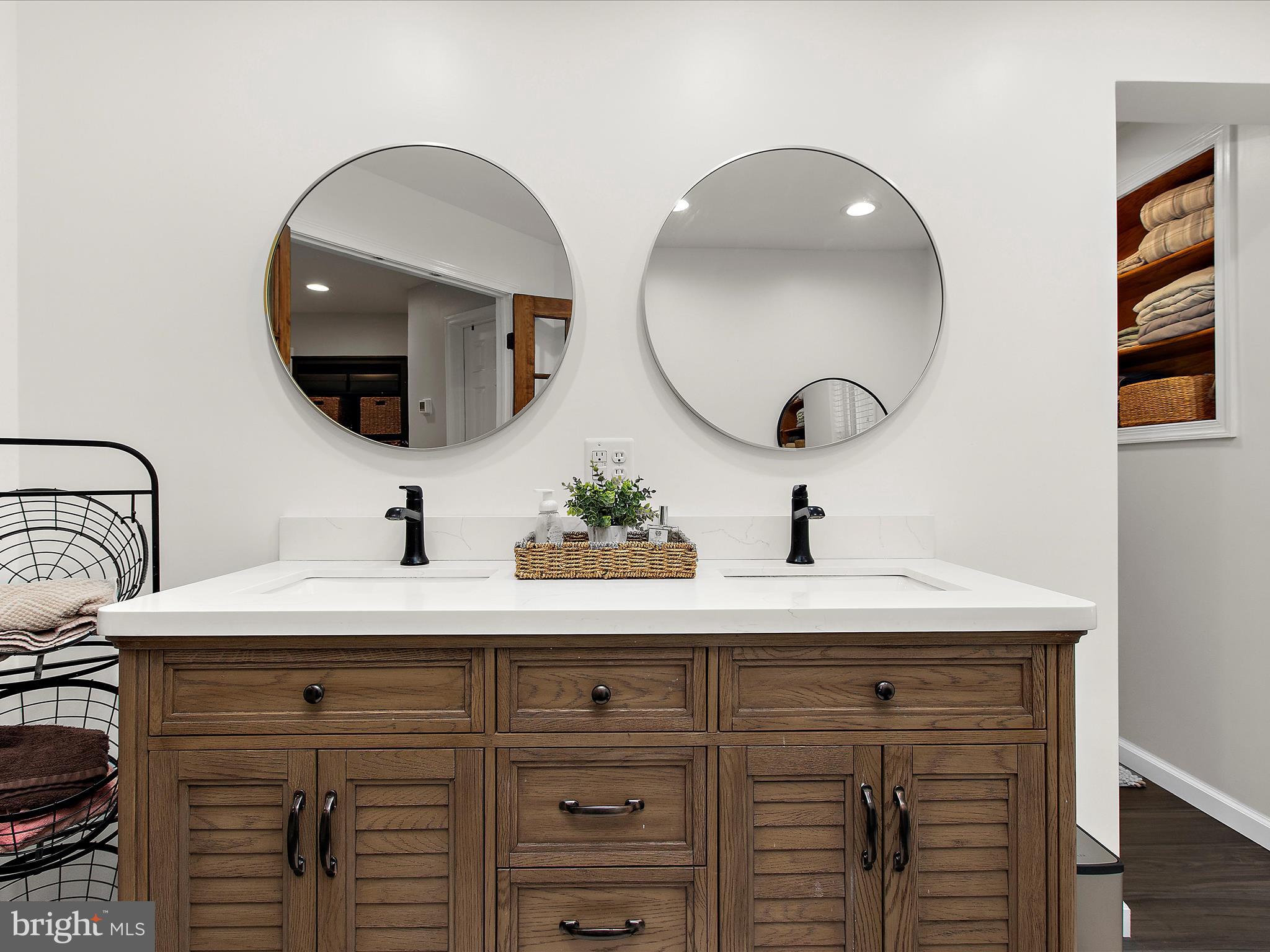1217 Somerset Road Severn, MD 21144 - Photo 25 of 86 a sink with a mirror and vanity