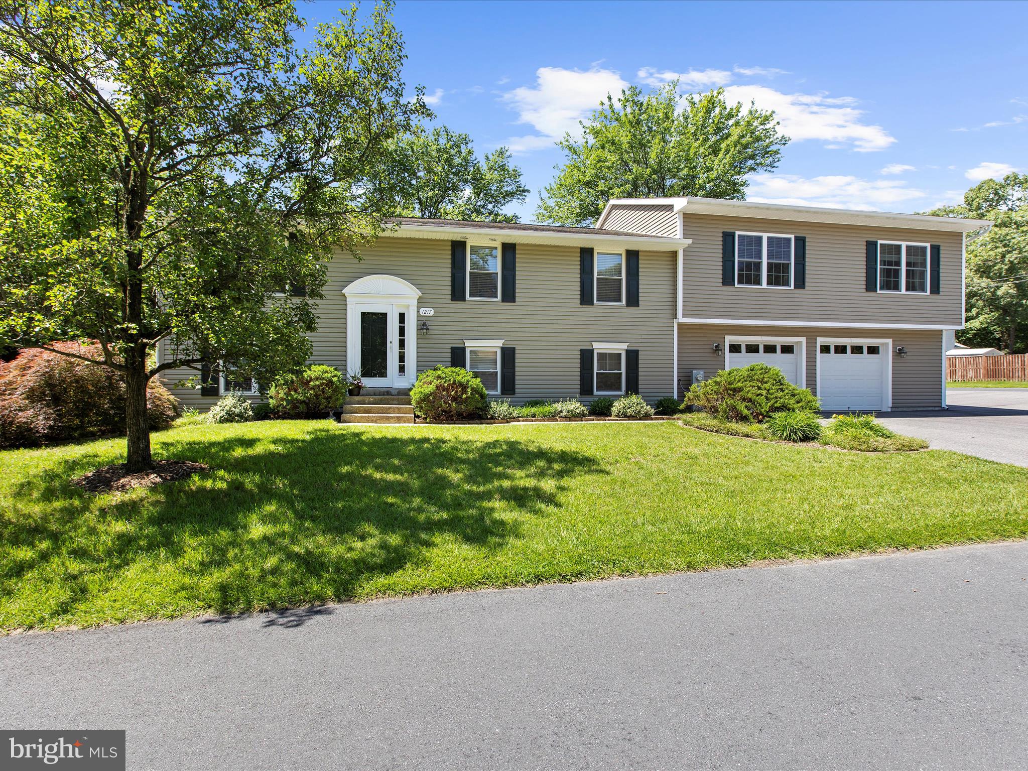 1217 Somerset Road Severn, MD 21144 - Photo 3 of 86 a front view of a house with a garden and trees