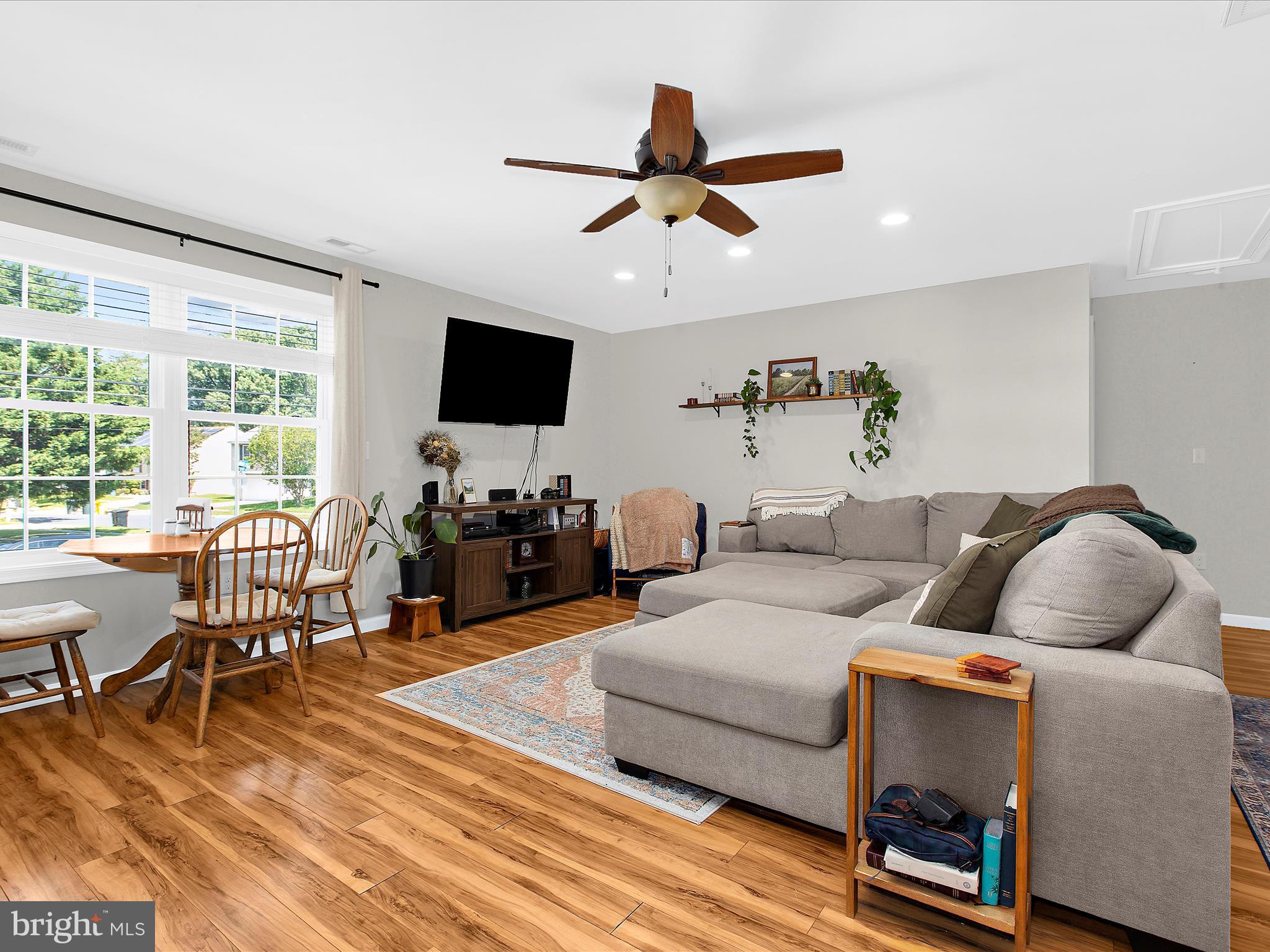 1217 Somerset Road Severn, MD 21144 - Photo 45 of 86 a living room with furniture and a flat screen tv with wooden floor