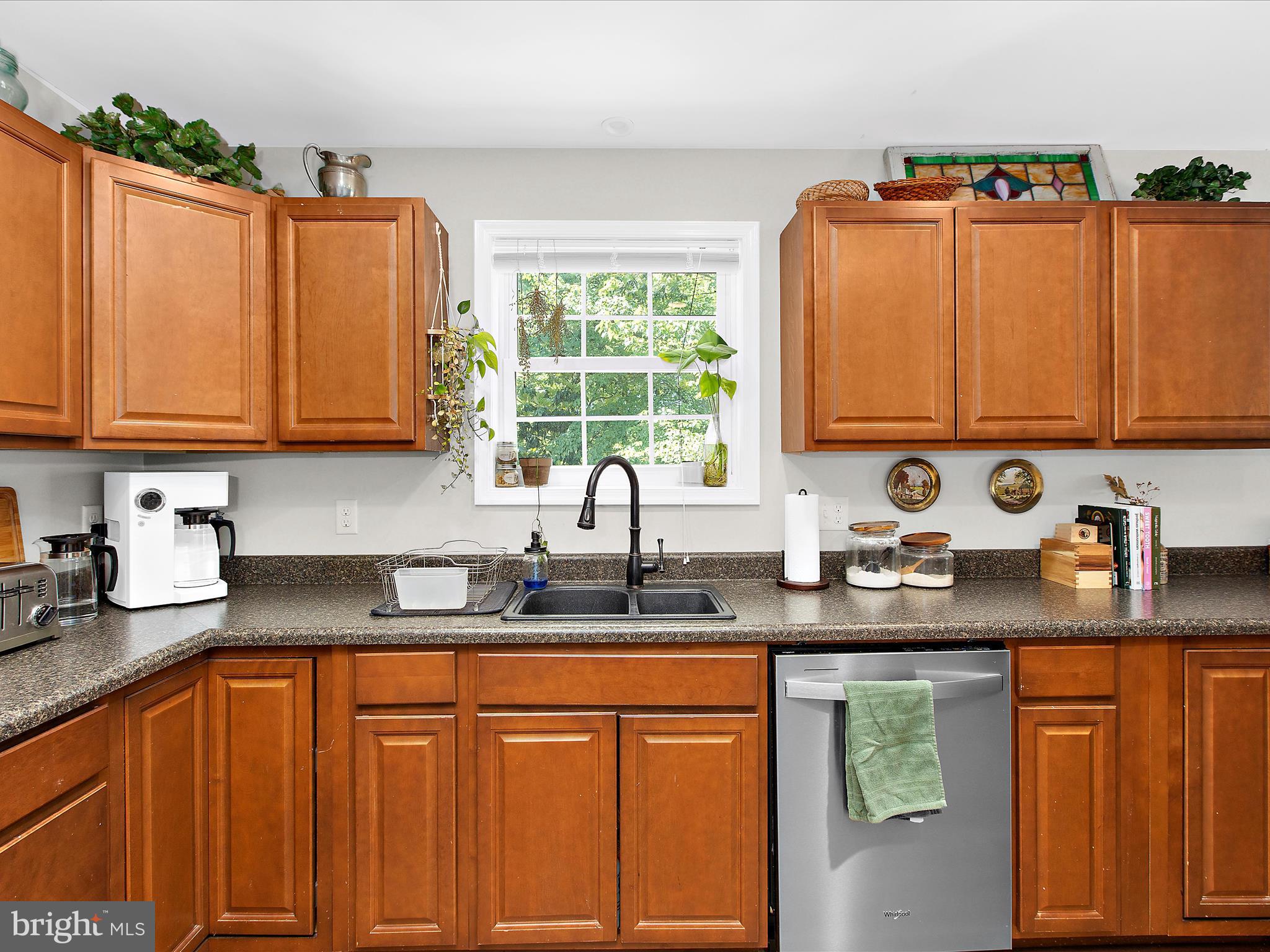 1217 Somerset Road Severn, MD 21144 - Photo 51 of 86 a kitchen with stainless steel appliances granite countertop a sink a microwave cabinets and a refrigerator