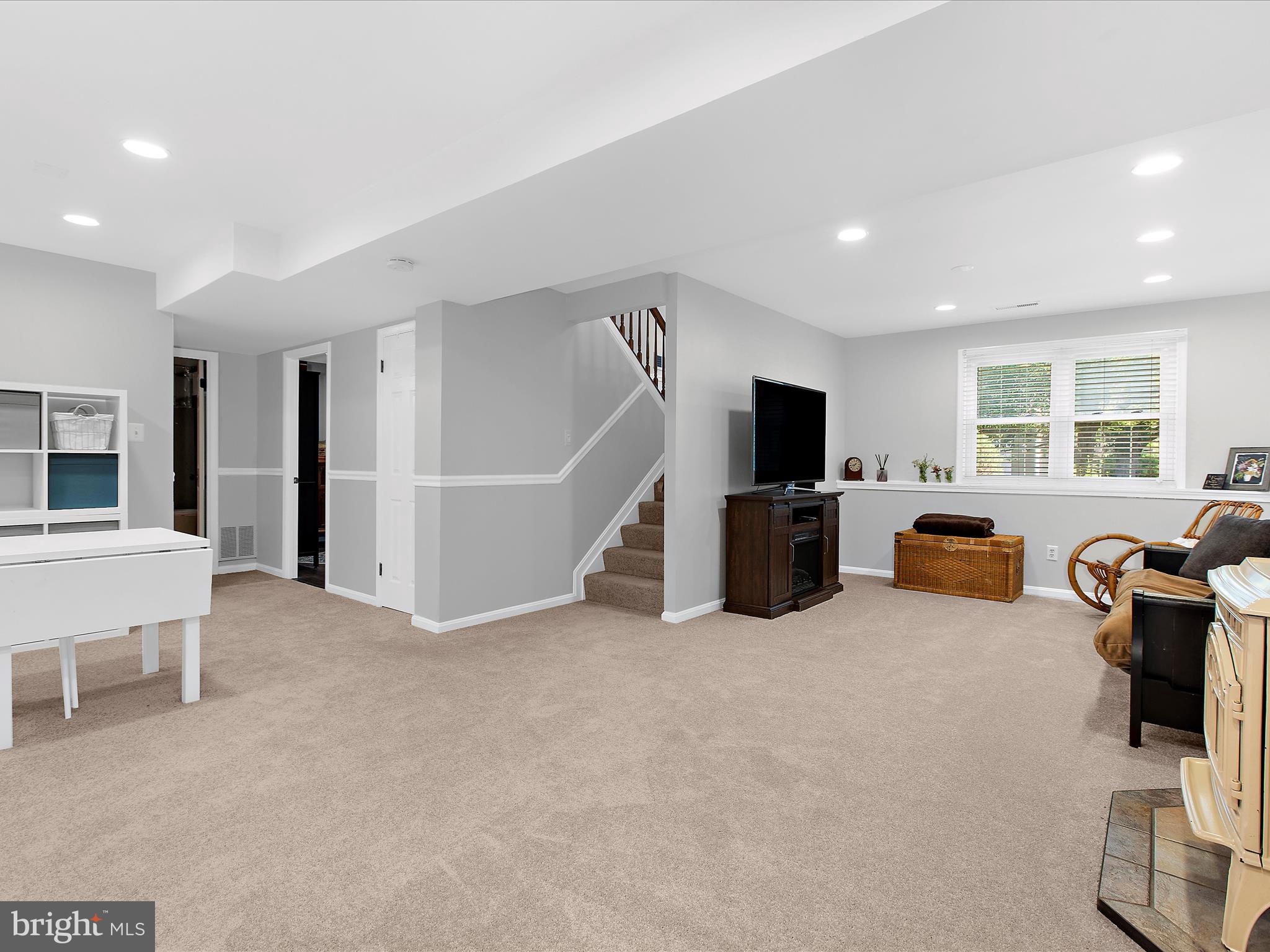 1217 Somerset Road Severn, MD 21144 - Photo 60 of 86 a living room with furniture and a flat screen tv