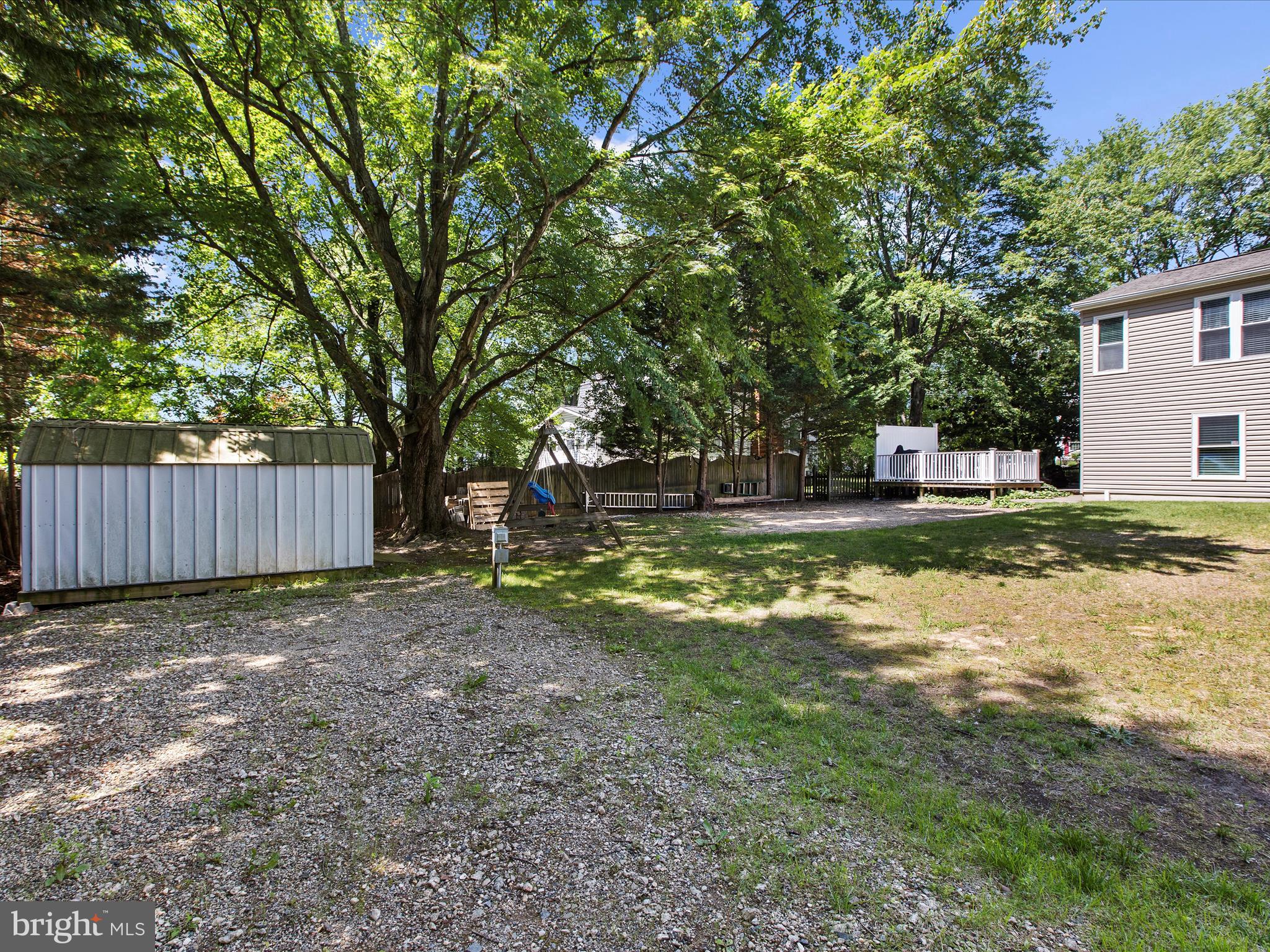 1217 Somerset Road Severn, MD 21144 - Photo 79 of 86 a view of a backyard with large trees and wooden fence