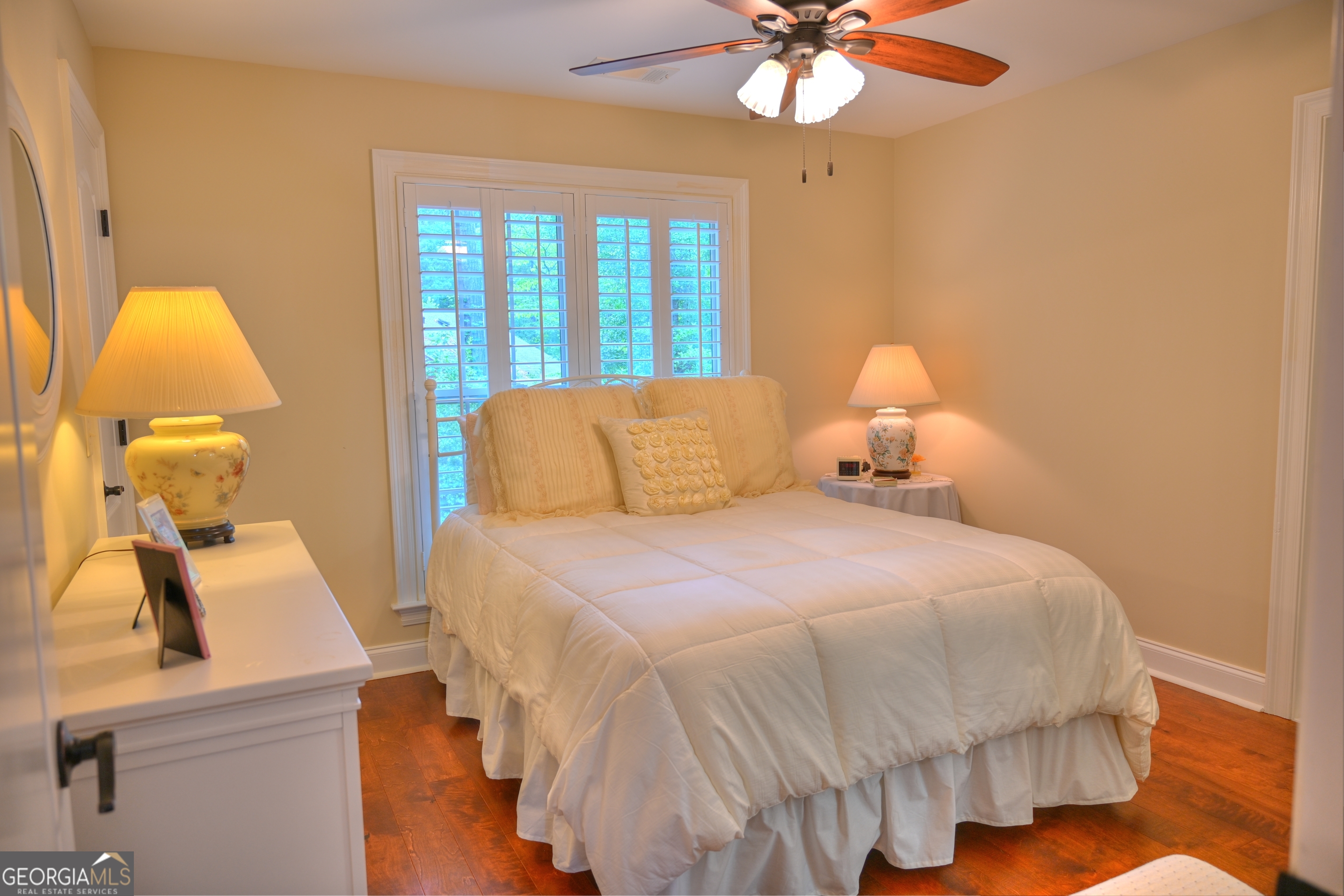 7381 Lullwater Road Columbus, GA 31904 - Photo 15 of 47 a bedroom with a bed and a chandelier