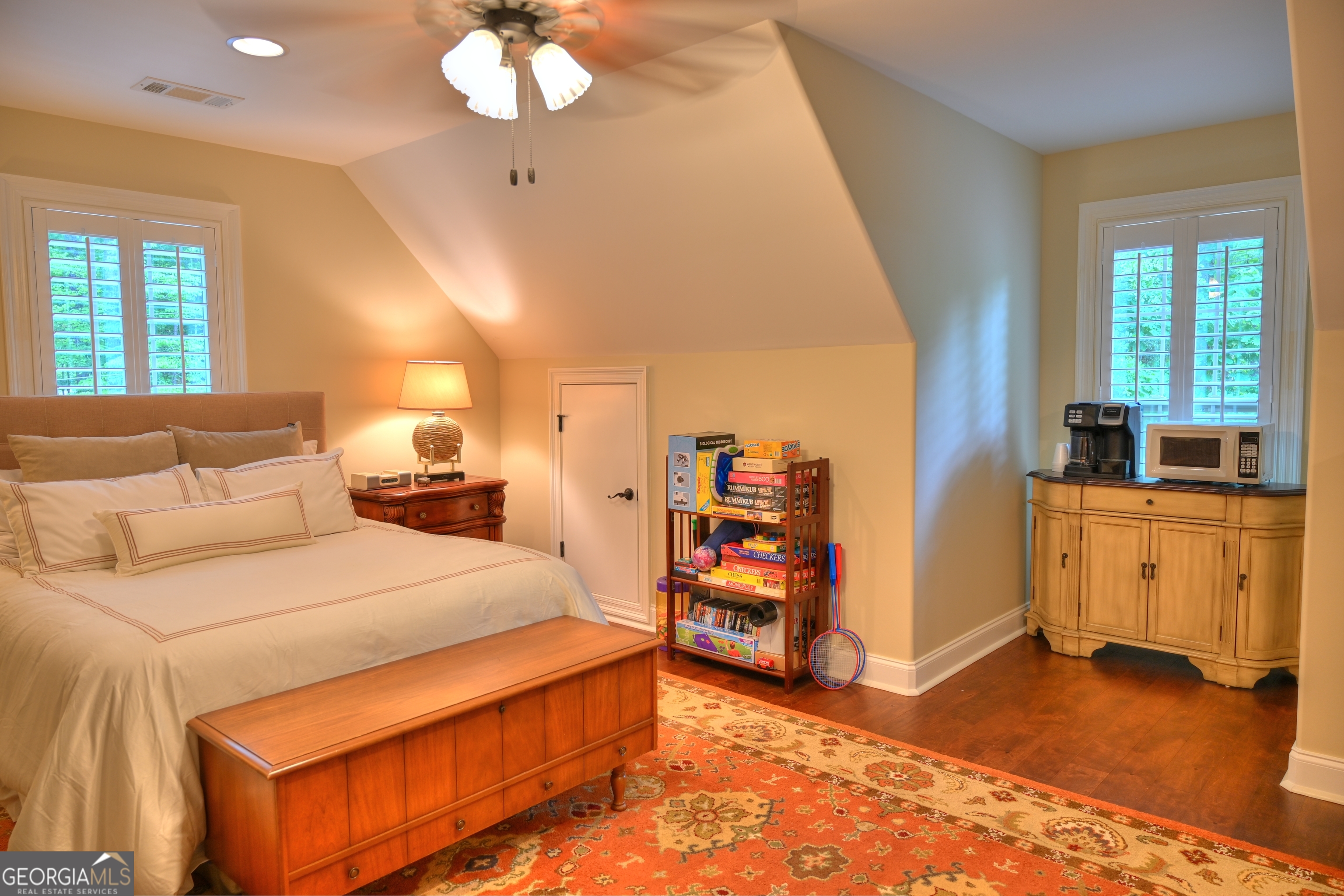 7381 Lullwater Road Columbus, GA 31904 - Photo 17 of 47 a bedroom with a bed and a chandelier