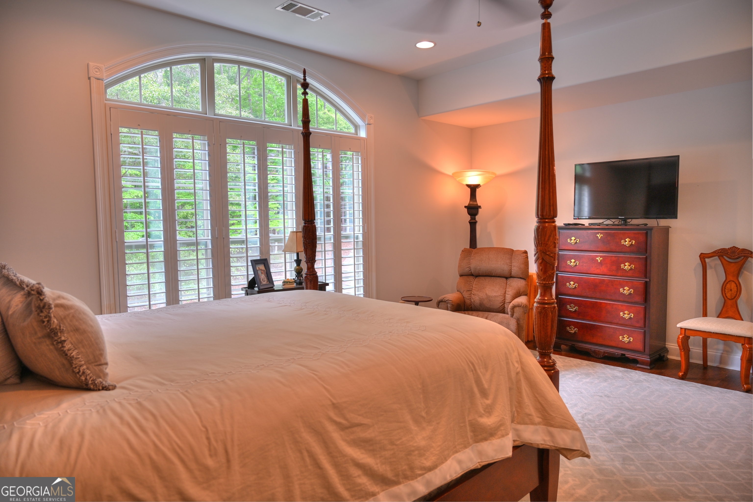 7381 Lullwater Road Columbus, GA 31904 - Photo 22 of 47 a bedroom with a bed and a flat tv screen on dresser