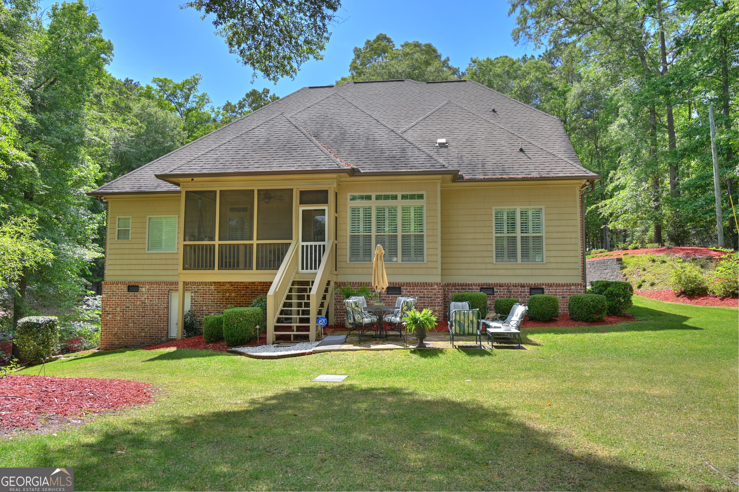 7381 Lullwater Road Columbus, GA 31904 - Photo 32 of 47 a view of a house with backyard sitting area and garden
