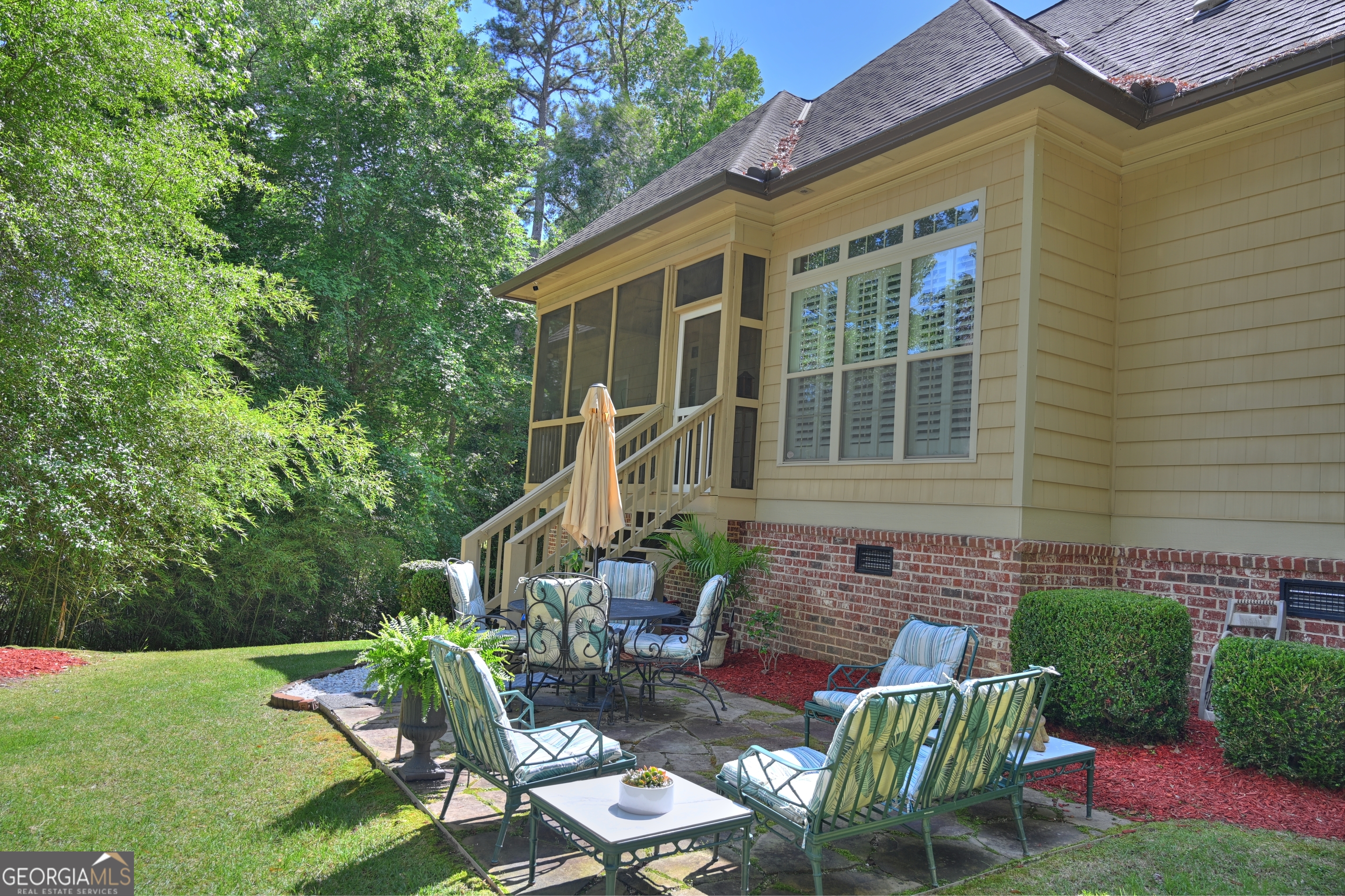 7381 Lullwater Road Columbus, GA 31904 - Photo 33 of 47 a view of backyard with table and chairs and potted plants