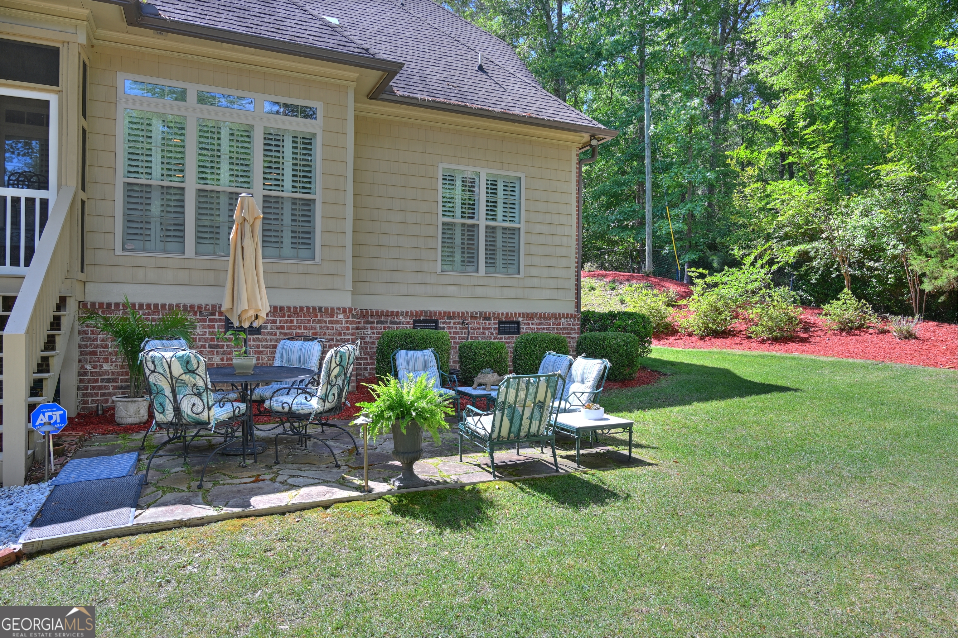 7381 Lullwater Road Columbus, GA 31904 - Photo 35 of 47 a view of a chair and table in backyard of the house