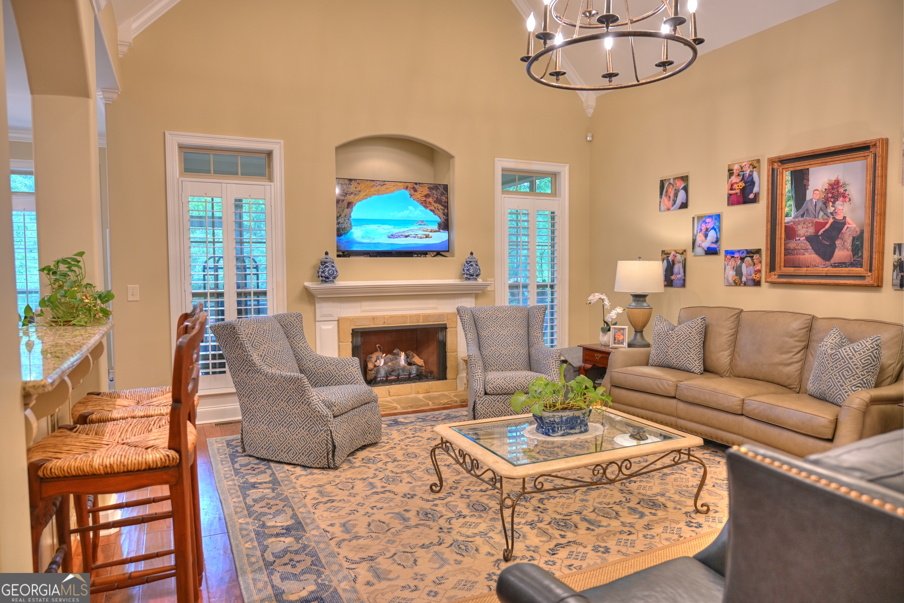 7381 Lullwater Road Columbus, GA 31904 - Photo 39 of 47 a living room with furniture a chandelier and a fireplace